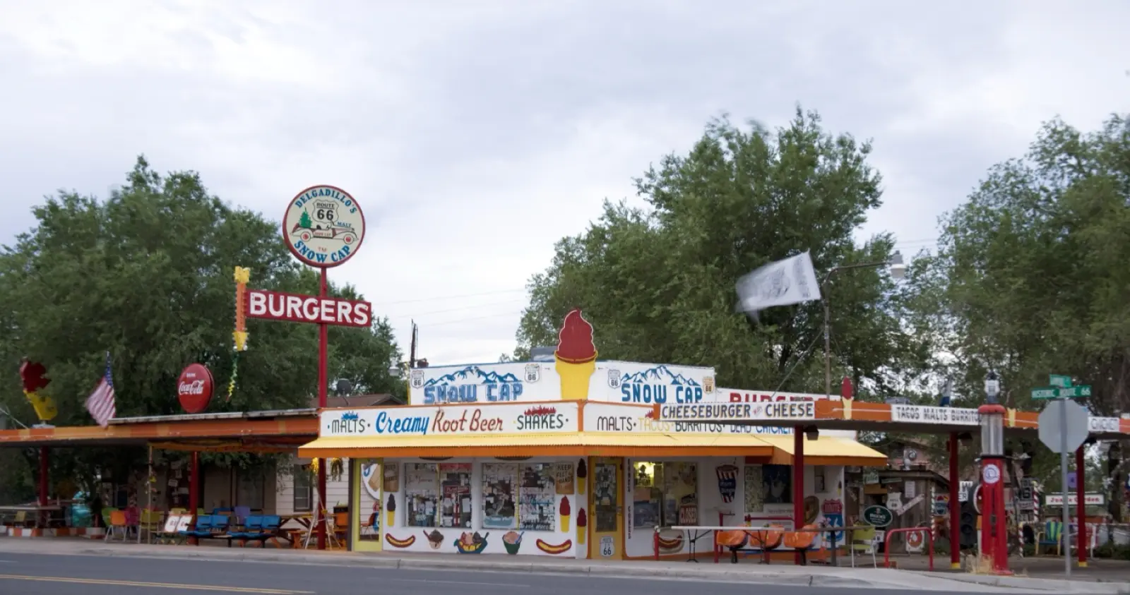 Delgadillo's Snow Cap drive-in in Seligman, Arizona, with its painted sign, picnic tables and vintage cars
