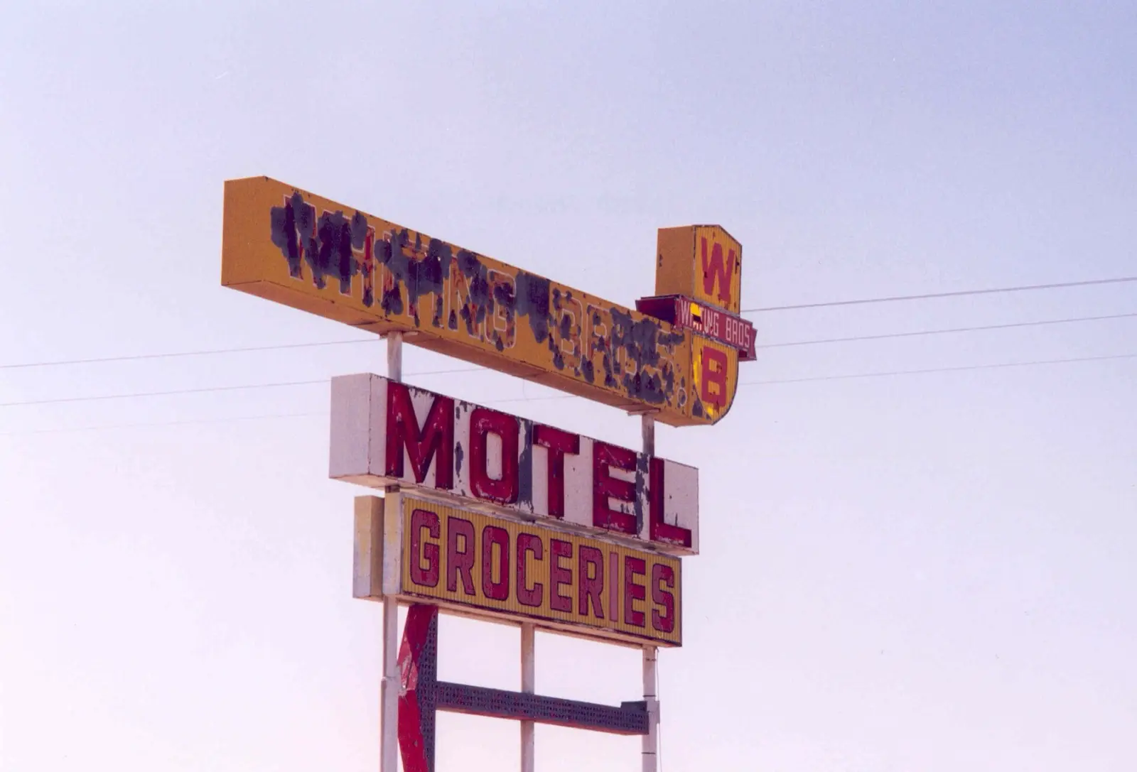 Abandoned Whiting Brothers motel and grocery neon signs standing beside old Route 66 in New Mexico
