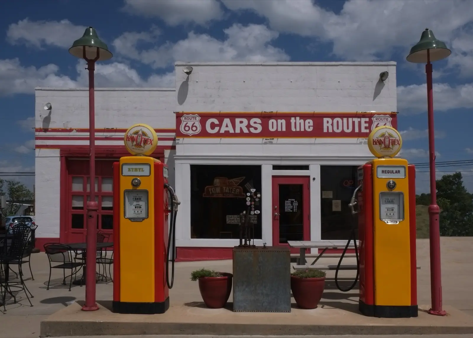White and red Cars on the Route station with two yellow vintage gas pumps and green lamp posts in Galena, Kansas