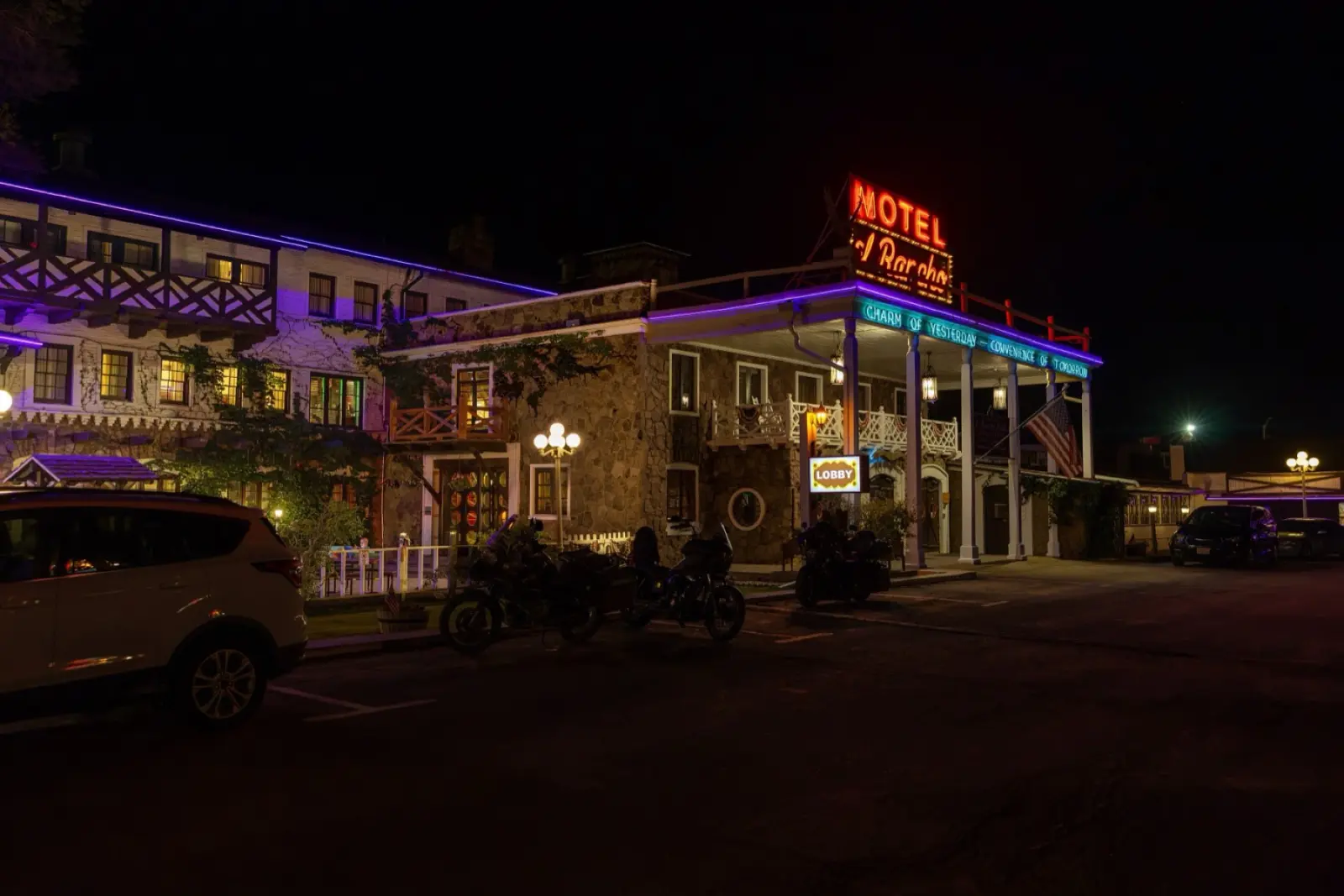 Hotel El Rancho in Gallup, New Mexico, at night with its red Motel El Rancho neon sign and lit balconies