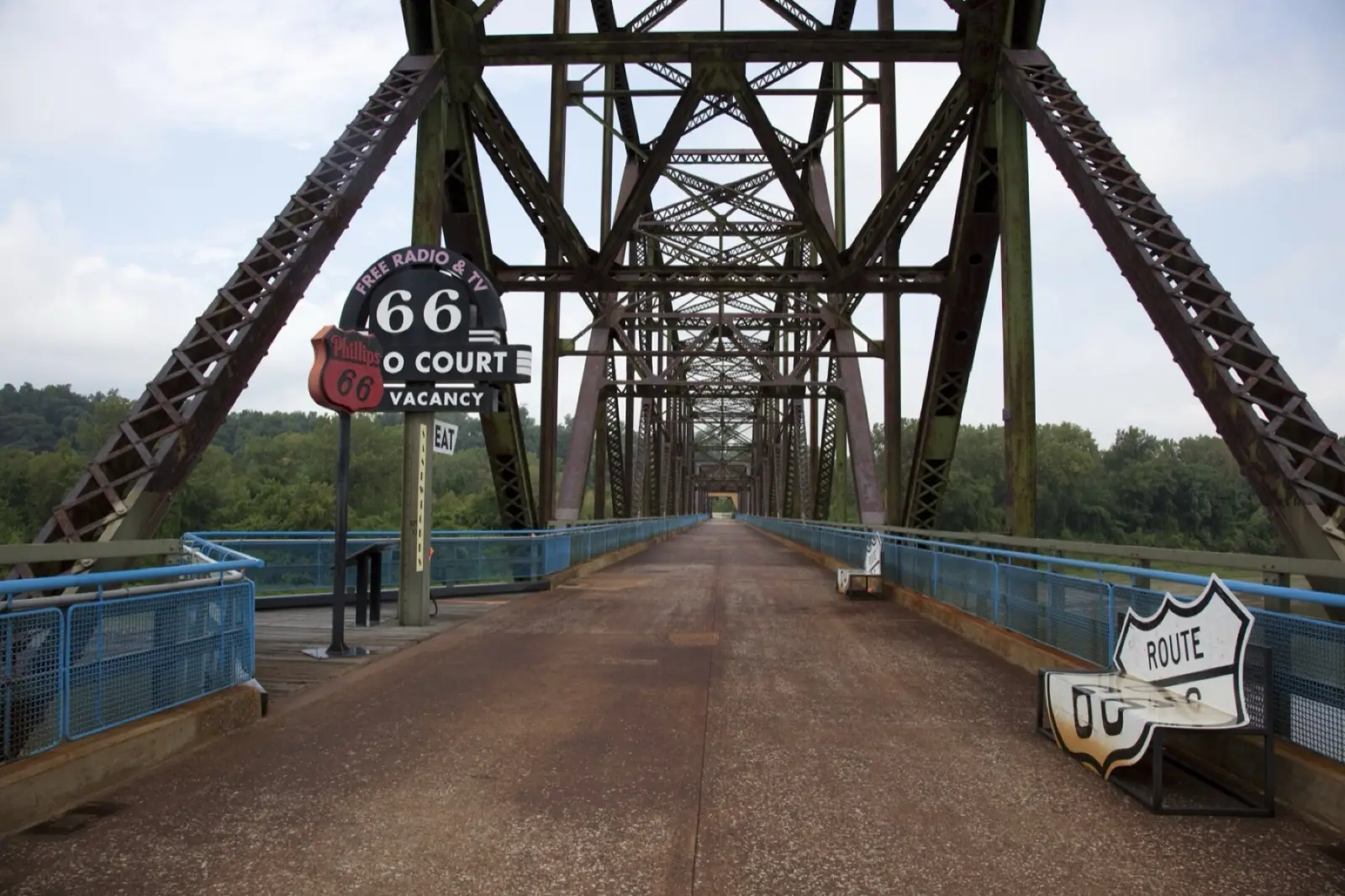 The Old Chain of Rocks Bridge over the Mississippi, with a vintage Route 66 sign and a shield-shaped bench on the walkway